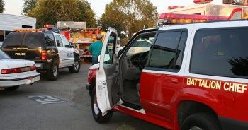 Active scene with police cruisers and fire battalion chief vehicle